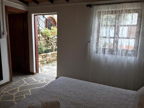 a bedroom with a bed and a window at Cobblers in Maroni