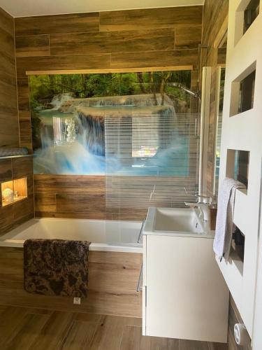 a bathroom with a tub and a sink at Mazurski Reset in Wilnowo