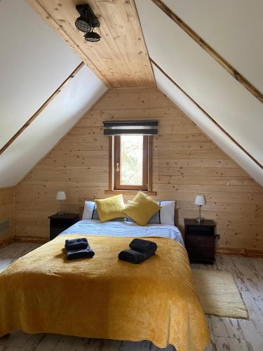 a bedroom with a large bed in a attic at Mazurski Reset in Wilnowo