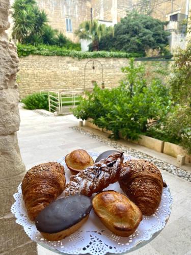 a plate of donuts and pastries on a table at B&B Kabala in Lecce