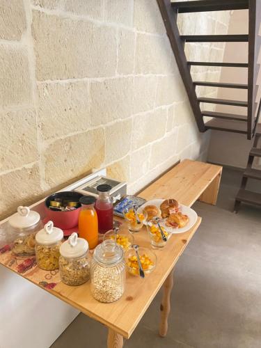 a table with food and drinks on top of it at B&B Kabala in Lecce