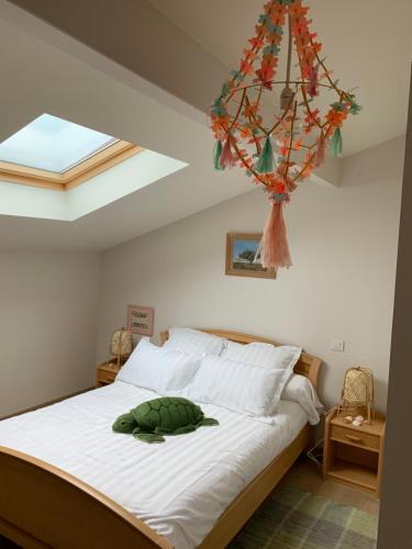 une chambre avec un lit et un lustre dans l'établissement Myfamily, à Capbreton