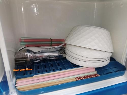 a refrigerator with a toilet and a pile of books at Heart Bentong Guest House 文冬心宿民宿 Bentong Homestay in Bentong