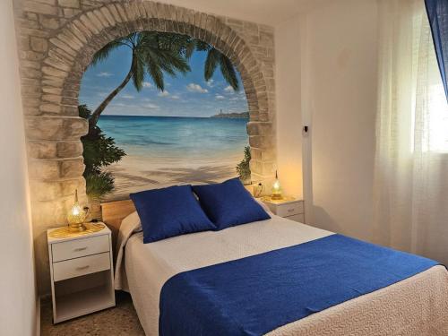 a bedroom with a bed with a view of the ocean at FARO PLAYA in Cullera