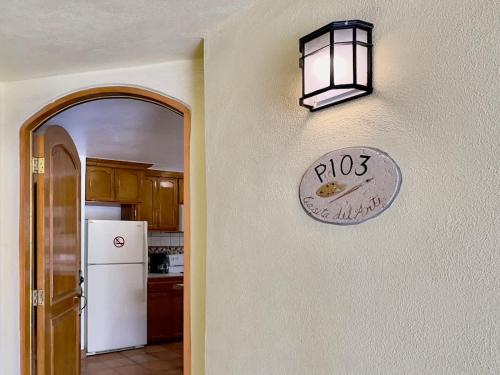 a kitchen with a clock on the wall at Puerto Nuevo Surf Casita del Arte 1BR with pool in Raulis