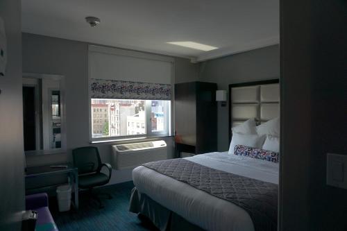 a hotel room with a bed and a window at Umbrella Hotel Bronx in Bronx