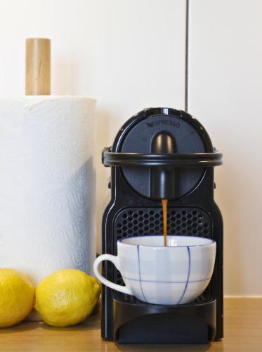 a espresso maker is making a cup of coffee at Apartament Studio 208 in Biała Podlaska