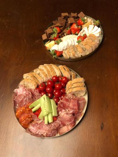 two plates of different types of food on a table at La Tour du Blé - gîtes et chambres d'hôtes in Salornay-sur-Guye