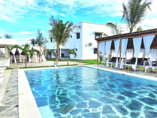 a swimming pool in front of a house at Villa SunShine exclusive in Watamu