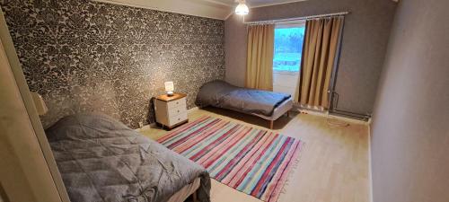 Un dormitorio pequeño con una cama y una ventana. en Omakotitalo Karhula, en Kotka