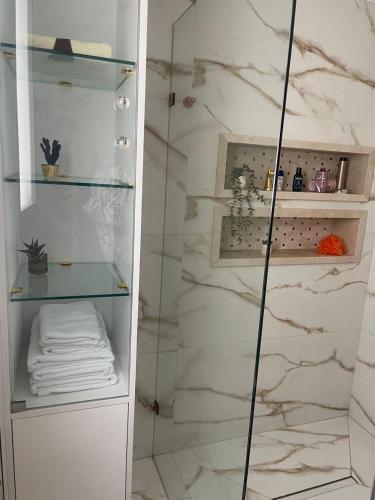 a bathroom with a shower with a glass door at Monte Cabo in Cabo Negro