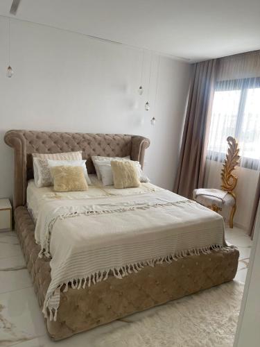 a bedroom with a large bed in a white room at Monte Cabo in Cabo Negro