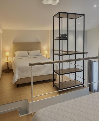 a bedroom with a bed and a book shelf at Thalasson Beach House in Koroni