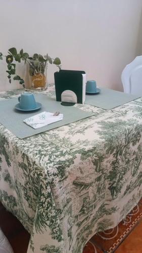 a table with a table cloth on it with a table sidx sidx at Relais L'Eucalipto in SantʼAgata deʼ Goti