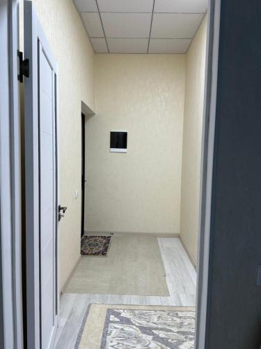 an empty hallway with a door to a room at Pamir Tower Apartments in Khorog
