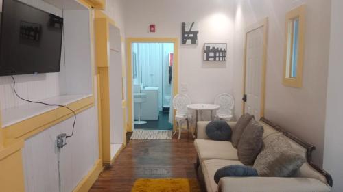 a living room with a couch and a flat screen tv at Michie Hostel in Providence