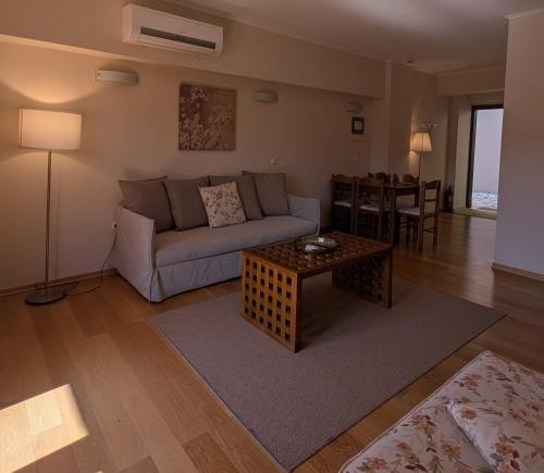 a living room with a couch and a table at Althea Apartments in Katakolon