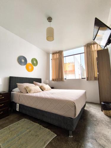 a bedroom with a bed and a large window at Killamoon House Paracas in Paracas