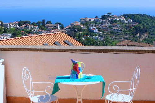 a table and chairs on a balcony with a view at De Pando Panoramic Suites 1096 in Scala