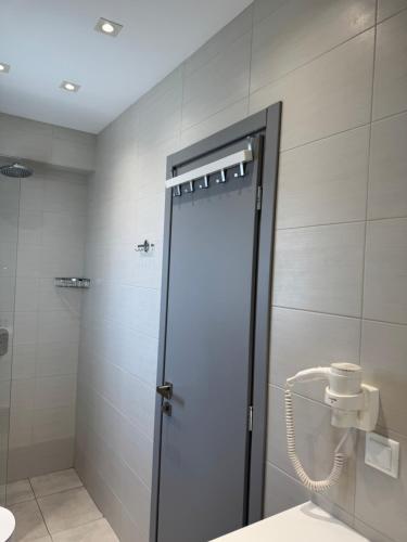 a shower with a glass door in a bathroom at Anemoni Beach Hotel in Skiathos Town