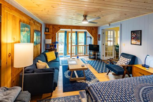 a living room with a couch and a table at Cavalier Cottage B&B in Shelburne Falls