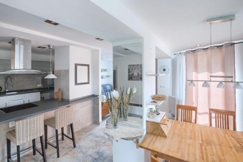 a kitchen and dining room with a table and chairs at Apartmány Gaia a Luna 
