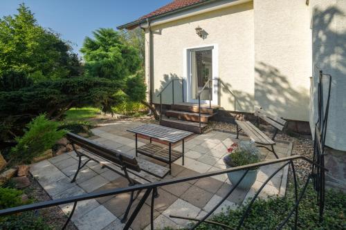 a patio with a bench and a table at Apartmány Gaia a Luna 