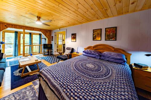 a bedroom with a large bed in a room at Cavalier Cottage B&B in Shelburne Falls