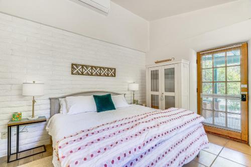 a white bedroom with a large bed and a window at Casa Paloma Studio Artsy and Airy with Hot Tub Access in Patagonia