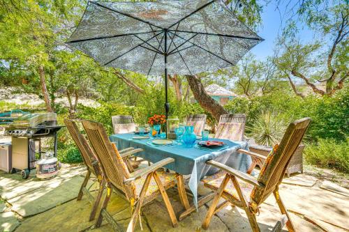 a table and chairs with an umbrella on a patio at Casa Paloma Studio Artsy and Airy with Hot Tub Access in Patagonia