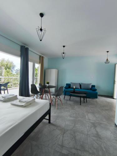 a living room with a bed and a couch at Beachway luxury studio A B in Nea Peramos