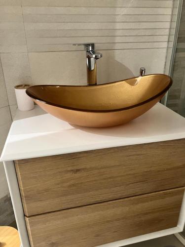 a wooden sink on a counter in a bathroom at Bibi Pied-à-Terre Vetra - Two Rooms Apartment in Milan