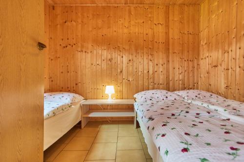Postel nebo postele na pokoji v ubytování Aga Domki
