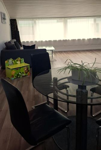 a living room with a glass table and a couch at Muota River Loft & Muota Industry Apartment near Stoos in Muotathal