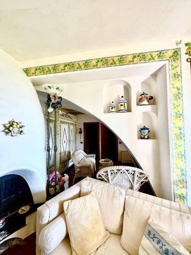 a living room with a couch and a fireplace at Villa Luxe Mare & Parco Privato in Vesima