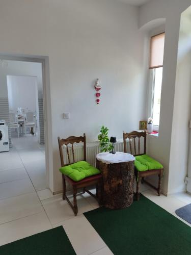 a living room with two chairs and a table with a tree stump at Agroturystyka Puchatek in Rebiszów