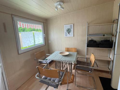 a small dining room with a table and chairs at Campingplatz Wohnwagen mit Vorzelt in Affing