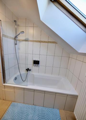 a bathroom with a shower and a bath tub at Terre - Le - Sart in Neufchâteau