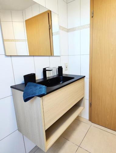 a bathroom with a black sink and a mirror at Terre - Le - Sart in Neufchâteau