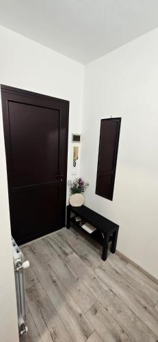 a room with a door and a bench and a mirror at SLEEP & GO Pisa in Pisa