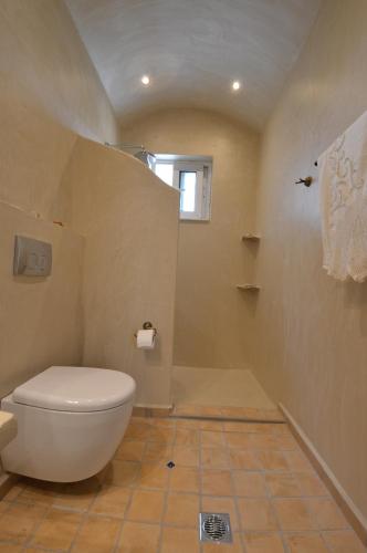 a bathroom with a white toilet in a room at Kathara Bay Apartments in Faliraki