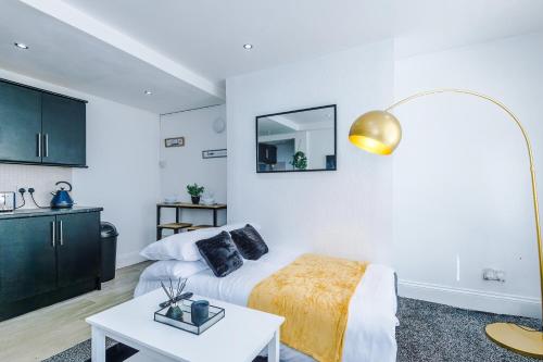 a white room with a bed and a table at Luxury 1 bedrooom house, sleeps 4, free parking in Queensbury