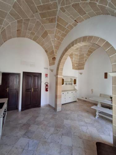 a large room with a stone ceiling and a kitchen at Dimora Matteotti in Nardò