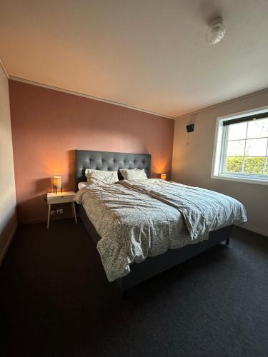 a bedroom with a large bed and a window at Leilighet nært sentrum in Stryn