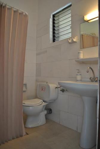 a bathroom with a toilet and a sink at Thalassa Studios in Loutrá Kounoupélli
