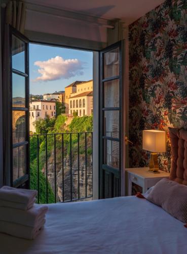 a bedroom with a bed and a window with a view at Las Vistas Residence - Best Views in Ronda in Ronda
