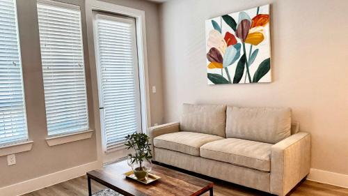 a living room with a couch and a table at Modern 2- Bed Apt Pool & Gym in Austin