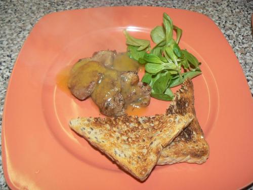 a orange plate of food with meat and a salad at Penzion Mirabel in Bešeňová