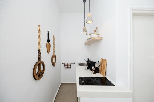 a kitchen with white walls and a sink at Flisvos beach studios in Naxos Chora