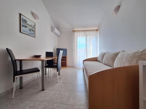 a living room with a couch and a table at Apartments and Rooms Saric in Jadrija